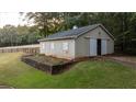 Detached barn with large doors and garden at 992 Pj East Rd, Covington, GA 30014