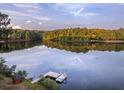 Scenic lakefront property with dock and pontoon boat at 992 Pj East Rd, Covington, GA 30014
