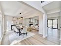 Open concept dining area with a large table, modern light fixture and an adjoining living space at 5702 Brynwood Nw Cir, Acworth, GA 30101
