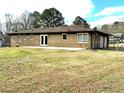 Rear view of house, showcasing patio and fenced yard at 553 W Sandtown Sw Rd, Marietta, GA 30064