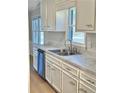 Bright kitchen with white cabinets, stainless steel appliances, and granite countertops at 553 W Sandtown Sw Rd, Marietta, GA 30064