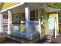 Front porch view of yellow house with white trim at 575 Rockwell Sw St, Atlanta, GA 30310