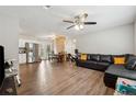 Open living area with L-shaped sectional sofa and wood-look floors at 9012 Hurst Ct, Jonesboro, GA 30238