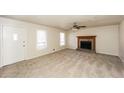 Spacious living room with neutral carpet, ceiling fan, and stone fireplace for a warm and inviting atmosphere at 380 Oak Landing Cir, Douglasville, GA 30134