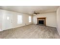 Inviting living room showcasing a stone fireplace, natural light, and neutral carpet, enhancing comfort at 380 Oak Landing Cir, Douglasville, GA 30134