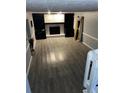 Large living room with a fireplace and dark grey wood-look flooring at 553 Wellington Way, Jonesboro, GA 30238