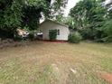 Single story house with green front lawn with well maintained and mulched landscaping at 4402 Highland Rd, Decatur, GA 30035