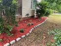 Lawn featuring a stone border and lush, fresh, vibrant red mulch highlighting the flower beds at 4402 Highland Rd, Decatur, GA 30035