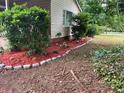 Landscaping with stone border and fresh mulch highlighting the flower beds and shrubs at 4402 Highland Rd, Decatur, GA 30035