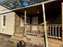 Wooden front porch with railing and steps at 4402 Highland Rd, Decatur, GA 30035