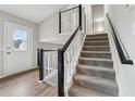 Modern staircase with a white and black railing leading to the second floor at 1259 Mill Lake Cir, Stone Mountain, GA 30088