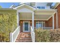 Brick front entrance with white columns and steps leading to the door at 3580 Bulloch Lake Rd, Loganville, GA 30052