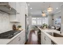 Modern kitchen featuring white cabinetry, stainless steel appliances, and a large island at 6736 Cadence Blvd, Sandy Springs, GA 30328