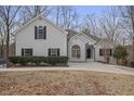 Charming white brick home with black shutters and arched windows on a tree-lined lot at 366 Greycoat Sw Blf, Marietta, GA 30064