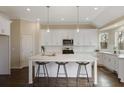 Bright eat-in kitchen featuring white cabinets, stainless steel appliances, and a large center island with bar seating at 366 Greycoat Sw Blf, Marietta, GA 30064