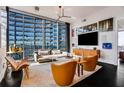 Bright living room boasts floor to ceiling windows and modern furniture in a high-rise building at 1065 Peachtree Ne St # 3102, Atlanta, GA 30309
