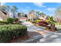 Lovely two-story brick home with attached garage, manicured lawn, and a long driveway at 3300 Greencastle Chase Ne, Marietta, GA 30062