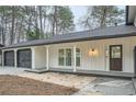 Modern farmhouse exterior with a charming front porch and two-car garage at 6523 Walden Pond Rd, Stone Mountain, GA 30087