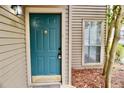 Close-up of the front door with a decorative knocker, set against the neutral siding and a small window at 2002 Country Park Se Dr, Smyrna, GA 30080