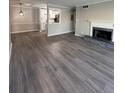 Spacious living room featuring modern flooring, a fireplace, and an open view to the kitchen area at 2002 Country Park Se Dr, Smyrna, GA 30080