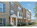 Brick townhouse with a red door and landscaping at 1184 Warner Park Ct, Decatur, GA 30033