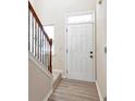 Entryway with white door and hardwood floors at 2375 Morgan Farm Dr, Buford, GA 30519