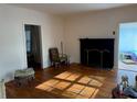 Living room with hardwood floors, fireplace, and access to sunroom at 2642 Joyce Ave, Decatur, GA 30032