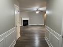 Bright hallway with hardwood floors leading to living room and fireplace at 5863 Seabright Ln, Atlanta, GA 30349