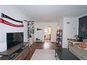 Living room with hardwood floors, TV, and view into the kitchen at 692 Argonne Ne Ave # 2, Atlanta, GA 30308