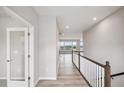 Bright hallway with hardwood floors and white trim, leading to a living area with natural light streaming through the windows at 14 Cambridge Ln, Dallas, GA 30157