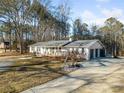 White brick ranch home with a two-car garage and long driveway at 2715 County Line Nw Rd, Acworth, GA 30101