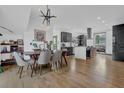 Open concept dining room with hardwood floors, modern table, and kitchen views at 1822 Avon Sw Ave, Atlanta, GA 30311