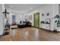 Bright living room featuring hardwood floors, modern decor, and a stylish green door at 1822 Avon Sw Ave, Atlanta, GA 30311