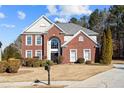 Brick two-story house with landscaped yard and driveway at 3164 Sw Wolf Club Sw Dr, Atlanta, GA 30349