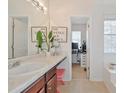 Main bathroom with double vanity, a soaking tub, and a small home office at 125 Hidden Creek Dr, Canton, GA 30114