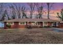 Brick ranch home with mature trees and a spacious yard at 1730 Carla Dr, Morrow, GA 30260