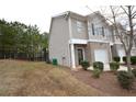 Townhome side view showcasing additional parking and wooded area at 3284 Pennington Dr, Lithonia, GA 30038