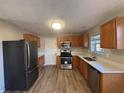 Kitchen with stainless steel appliances and light wood cabinets at 7645 Broadhurst Dr, Riverdale, GA 30296