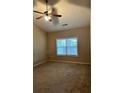 Spacious bedroom with ceiling fan and large window at 1025 City Park Dr, Mcdonough, GA 30252