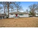 Charming house showcasing a gray brick exterior, complemented by a well-manicured front yard at 3215 Concord Cir, Smyrna, GA 30080