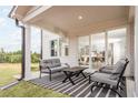 Covered patio with seating area, providing access to the home's interior at 4021 Adler Cir, Buford, GA 30519