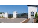 A stately stone entrance with black metal gates leads to the community and a well-manicured walkway creates a welcoming arrival at 1822 Butterfly Way, Marietta, GA 30066