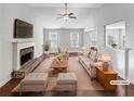 Virtually staged living room with a fireplace and hardwood floors at 3338 Carolina Wren Sw Trl, Marietta, GA 30060