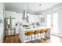 Bright kitchen with island, stainless steel appliances, and white cabinets at 98 Whitefoord Ne Ave # A, Atlanta, GA 30307