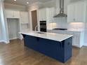 Modern kitchen with white cabinets, stainless steel appliances, and a large island at 148 Birch Tree Way, Cumming, GA 30040