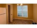 Bright dining area with large window and carpet flooring at 2087 Grove Way, Hampton, GA 30228