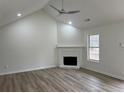 Living room with vaulted ceiling, fireplace, and hardwood floors at 265 Five Oaks Dr, Covington, GA 30014