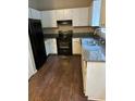 Efficient kitchen featuring white cabinets, gray countertops, and modern appliances at , Marietta, GA 30008