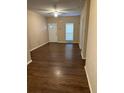 Inviting living room showcasing a light-filled space with sleek, dark wood flooring and neutral walls at , Marietta, GA 30008