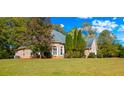 Brick house with a large backyard and lush landscaping at 101 Constance Dr, Locust Grove, GA 30248